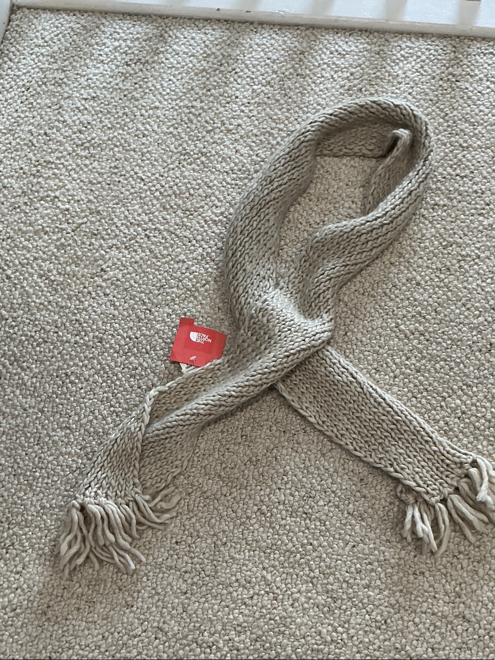The North Face Beige Knit Fringe Scarf with Red Logo Tag